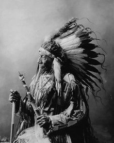 an old black and white photo of a native american man