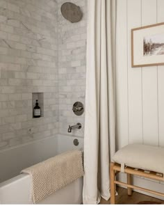 a bathroom with white brick walls and wood flooring is featured on the instagram