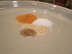 three different types of spices on a white plate