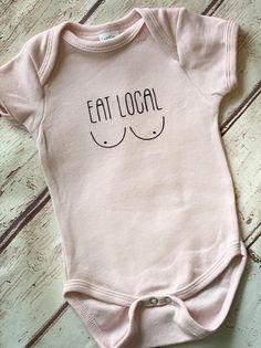 a pink baby bodysuit with the words eat local printed on it's chest