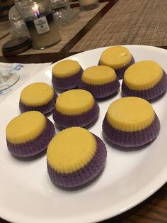 some purple and yellow cupcakes on a white plate