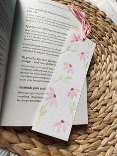 an open book sitting on top of a woven basket