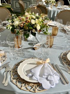 the table is set with silverware and flowers