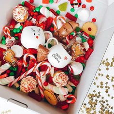 a box filled with lots of different types of candies and other holiday treats on top of a table