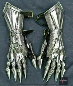 two metal gloves with spikes attached to them