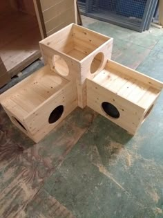 three wooden boxes sitting on top of a floor