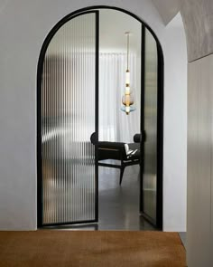 an arched glass door leading to a dining room