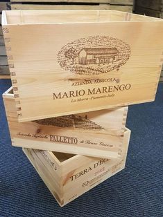 three wooden boxes stacked on top of each other with wine labels in the bottom and bottom