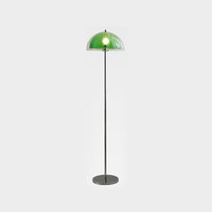 a floor lamp with a green light on the top and bottom, in front of a white background