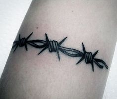 a tattoo with barbed wire on the arm