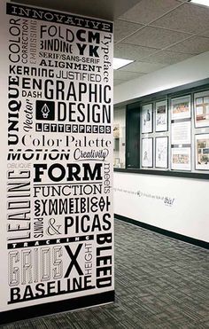 an office hallway decorated with black and white typograms