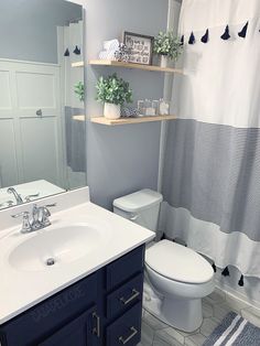 a white toilet sitting next to a bathroom sink