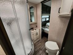 a bathroom with a toilet, sink and shower in it's own stall area