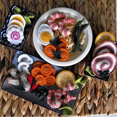 crocheted fruit and vegetable items displayed on woven placemats