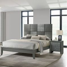 a bedroom with a bed, nightstands and windows