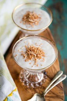 three glasses filled with yogurt and garnished with toast crumbs