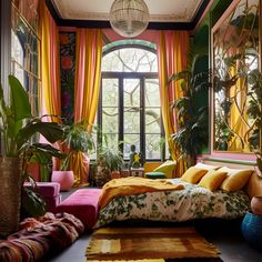 a bedroom decorated in bright colors with plants and rugs on the floor, along with large windows