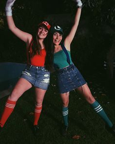 two women dressed up in costumes posing for the camera