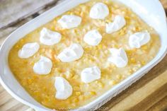 a casserole dish with marshmallows in it on a wooden table