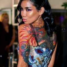 a woman with tattoos on her body and shoulder