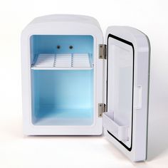 an open white refrigerator with blue door and shelves on the front, sitting against a white background