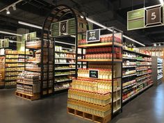 a grocery store filled with lots of different types of food and drinks on shelves next to each other