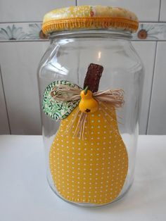 there is a glass jar with a yellow pumpkin inside