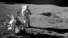 an astronaut standing on the surface of the moon