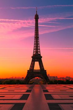 the eiffel tower is lit up in pink and purple at sunset, as seen on instagram