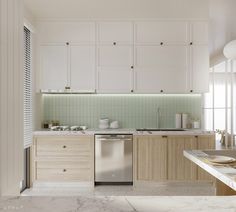 a white kitchen with marble counter tops and wooden cabinets, along with a dishwasher in the center