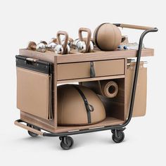 a kitchen cart with pots, pans and kettles on it's wheels