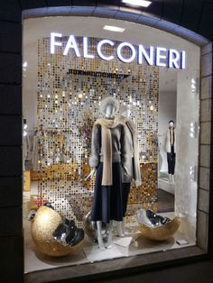 a window display with gold balls and shoes