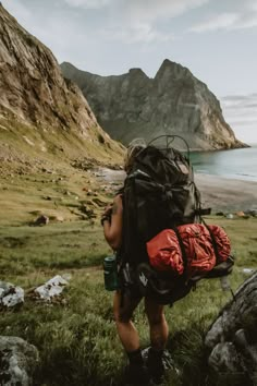 a person with a backpack walking up a hill