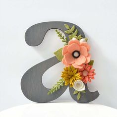 the letter s is decorated with flowers and leaves