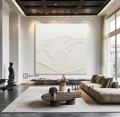 an elegant living room with large painting on the wall and modern furniture in front of it