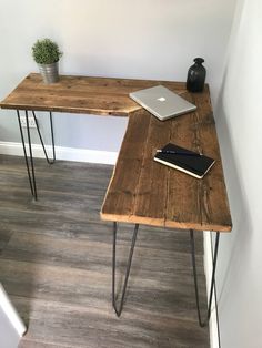 a wooden desk with hairpin legs and a laptop on it