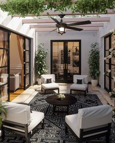 a living room filled with furniture and plants