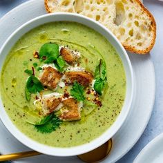 a bowl of soup with bread on the side