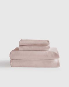 three sheets and two pillow cases in pale pink