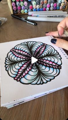 someone is drawing something with colored pencils