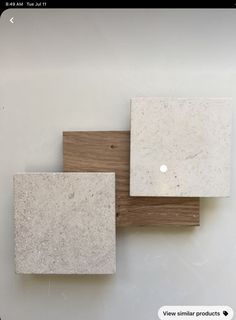 three white and brown square tiles sitting on top of each other