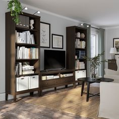 a living room filled with furniture and a flat screen tv on top of a wooden entertainment center