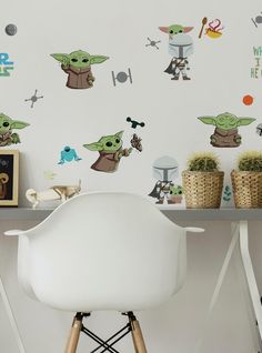 the baby yoda wall decals are on display next to a chair and table