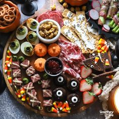 a platter filled with halloween food and candy, including crackers, pretzels