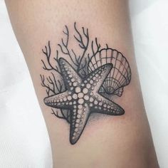 a starfish and coral tattoo on the leg