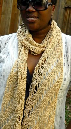 a woman wearing sunglasses and a knitted scarf