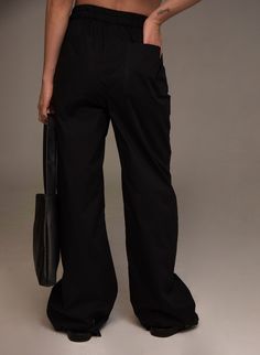 Made of cotton, these pants have an elastic waist for added comfort and a straight cut to lengthen the legs. You can wear it high-waisted or on the hips for a more modern look. Our Liberation collection is an interpretation of 90s tailoring. We introduce our cotton collection, recreating elements of the past to shape the present. An ode to the boldness of youth. COMPOSITION AND CARE 97% cotton - 3% elastane Back pocket Side pockets Mid-rise Handmade and not mass-produced. Wash this garment by ha Trendy Cotton Parachute Pants For Work, Baggy Cotton Pants For Work, Chic Wide Leg Parachute Pants For Streetwear, Wide Leg Cotton Pants With Belt Loops, Chic Black Wide Leg Pants For Streetwear, Chic Relaxed Fit Cotton Wide Leg Pants, Oversized Workwear Trousers, High-waisted Wide Leg Pants For Streetwear, Chic Cotton Wide Leg Pants With Relaxed Fit