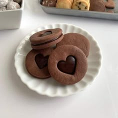 some heart shaped cookies are on a plate