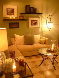 a living room filled with furniture and candles