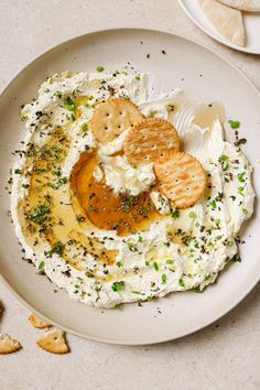 a white plate topped with mashed potatoes and crackers